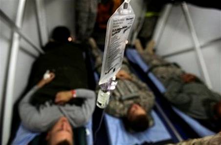 Wounded U.S. servicemen are seen on stretchers before boarding ...