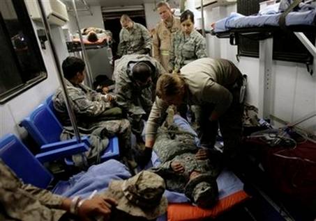 U.S. Air Force medical staff prepare to load wounded servicemen ...